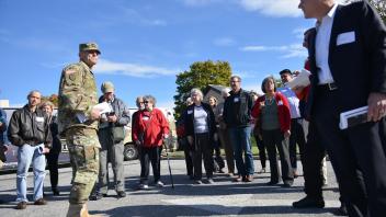 Army man talking to crowd 