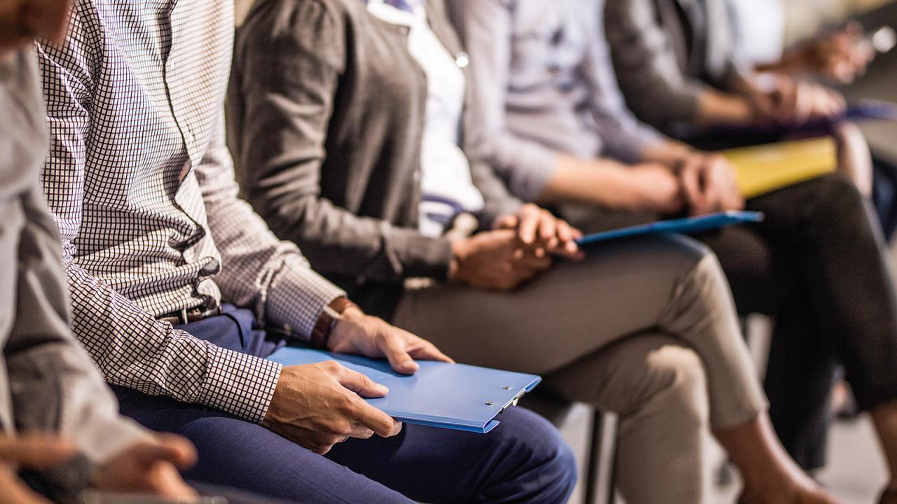 Line of people sitting in business attire