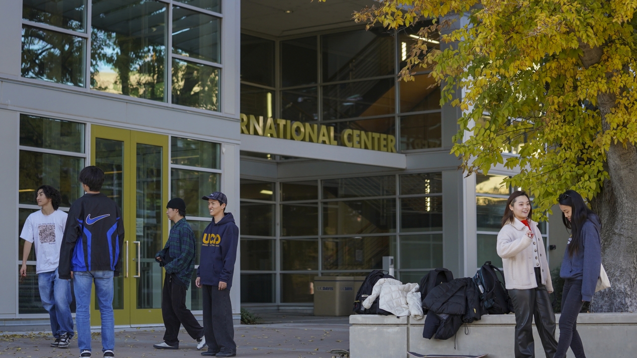 Photo outside of the international center with students walking in front