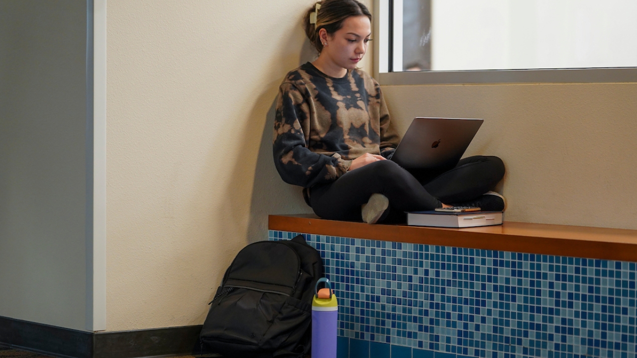 Second year Law student Ava Lindley studies outside of the IET compter rooms and media lab in the student community center on March 7, 2023.