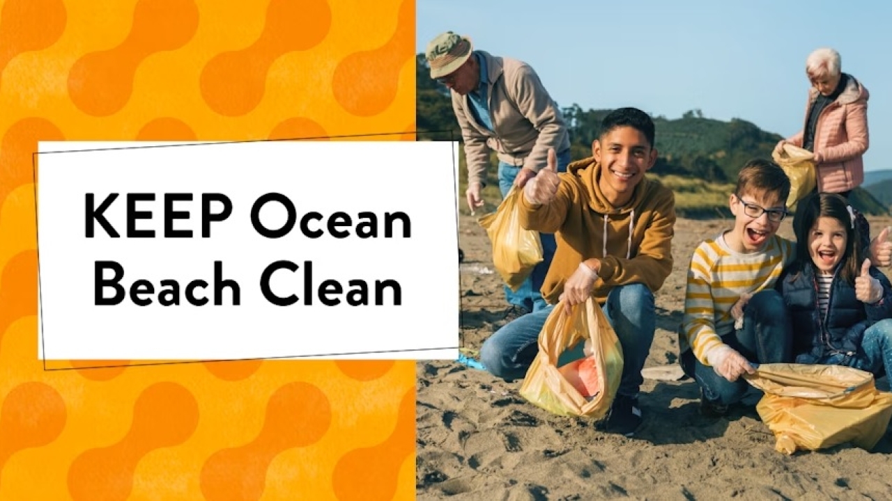 5 people are on a beach picking up trash; the 3 at the front are kids smiling at the camera while the 2 in the back are older and in the process of picking up trash. The words "KEEP Ocean Beach Clean" are displayed.