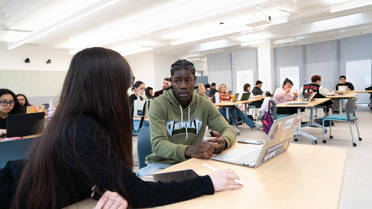 Students writing at a desk