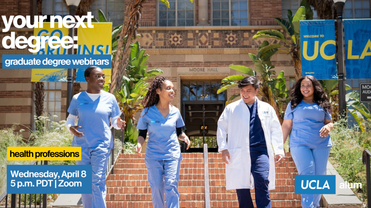 Four healthcare professionals walking together outside a university building, smiling and engaged.