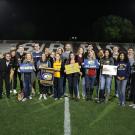 Group of Aggies on football field. 