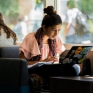 Person sitting down looking at their laptop.