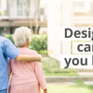 Image of healthcare professional in scrubs walking with an older patient 