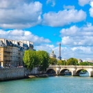 a river with the Eiffel wore in the distance