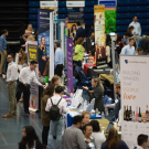 students standing at booths at a career fair