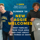 Five smiling diverse people posing before a blue-and-yellow UC Davis welcome banner