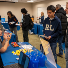 A student and their parent talk to a staff member about Summer Sessions