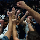 Men's basketball team in a huddle
